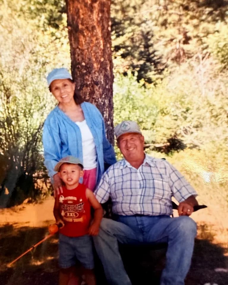 Angelica and Manuel Pacheco outdoors with a child in Taos